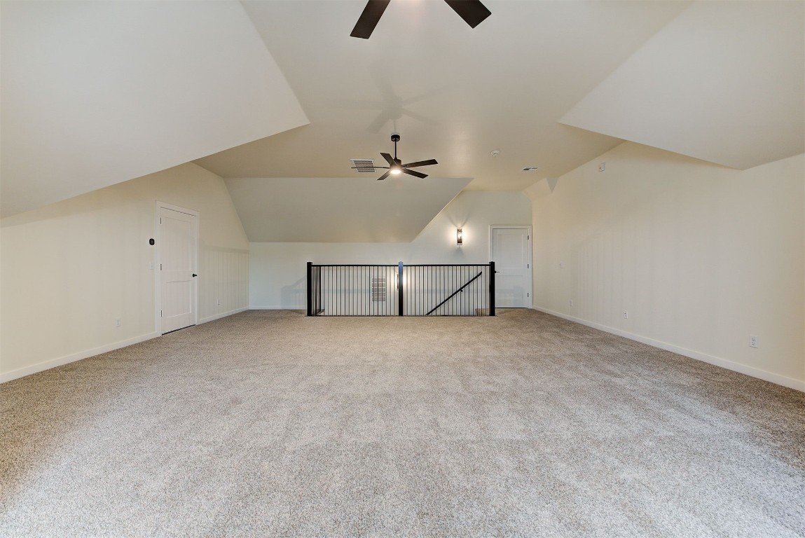 4124 Emery Drive, Edmond, OK 73034 additional living space featuring vaulted ceiling, carpet floors, and ceiling fan
