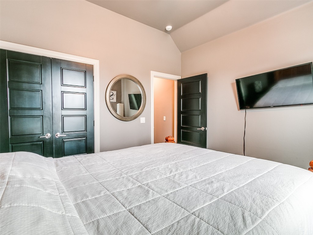 7208 NW 156th Street, Edmond, OK 73013 unfurnished bedroom with a closet and vaulted ceiling