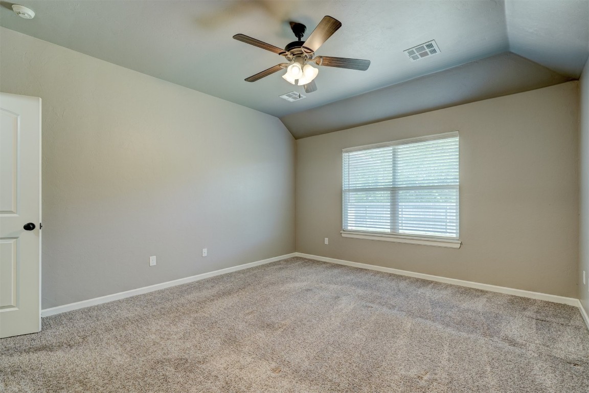 1727 W Blake Way, Mustang, OK 73064 empty room featuring lofted ceiling, ceiling fan, and carpet
