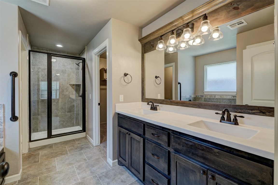 1727 W Blake Way, Mustang, OK 73064 bathroom featuring large vanity, an enclosed shower, double sink, and tile flooring