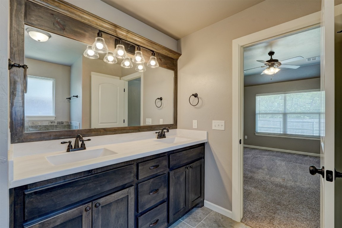 1727 W Blake Way, Mustang, OK 73064 bathroom featuring large vanity, ceiling fan, tile floors, and dual sinks