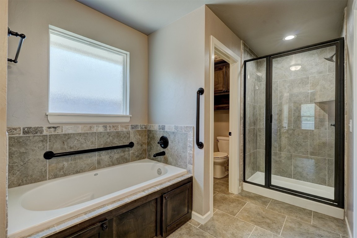 1727 W Blake Way, Mustang, OK 73064 bathroom with independent shower and bath, toilet, and tile floors