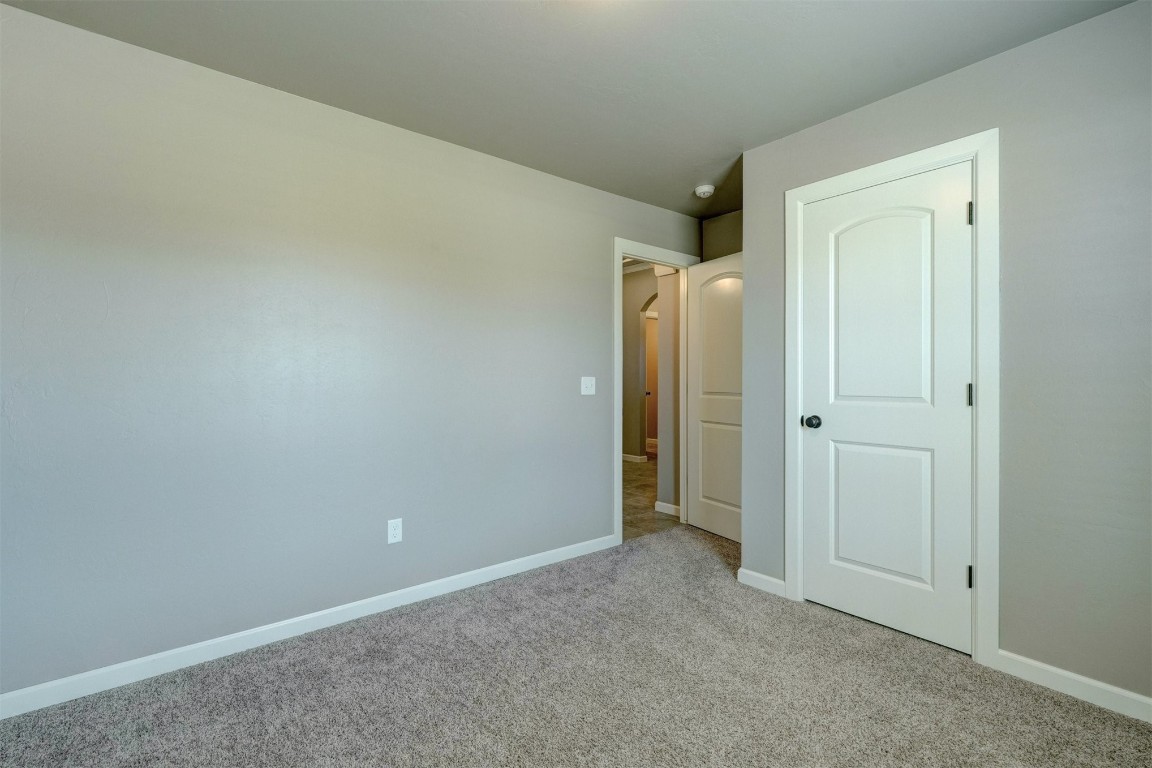 1727 W Blake Way, Mustang, OK 73064 unfurnished bedroom featuring carpet