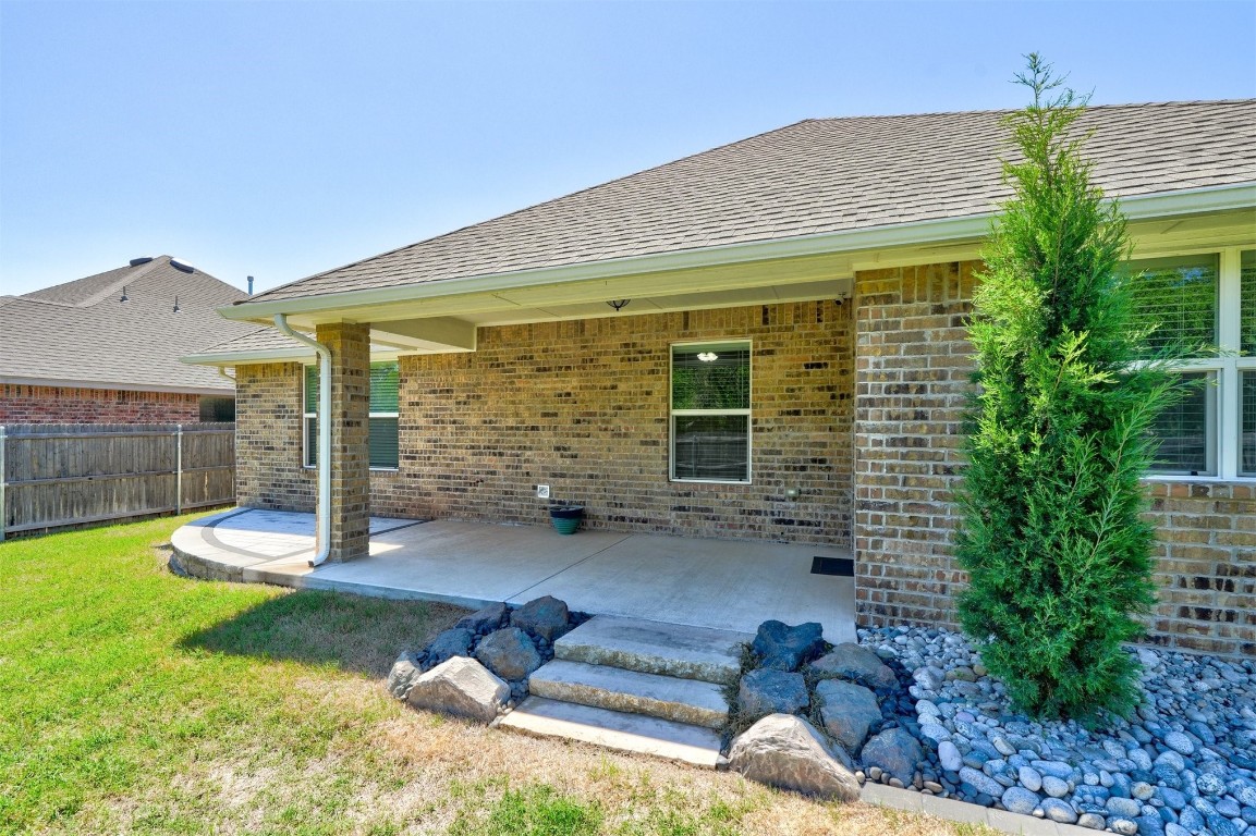 1727 W Blake Way, Mustang, OK 73064 back of property featuring a lawn and a patio area