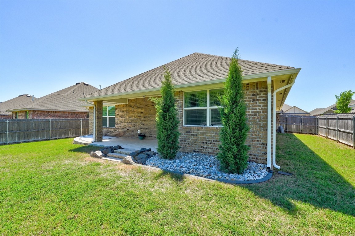 1727 W Blake Way, Mustang, OK 73064 back of property featuring a patio area and a yard