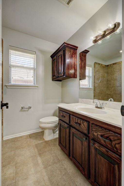 713 N Bobcat Way, Mustang, OK 73064 bathroom featuring toilet, tile flooring, and vanity