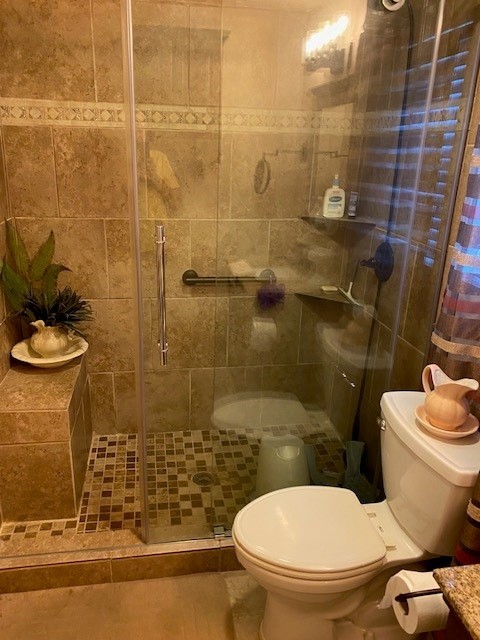10713 Admiral Drive, Oklahoma City, OK 73162 bathroom featuring walk in shower, tile floors, and toilet