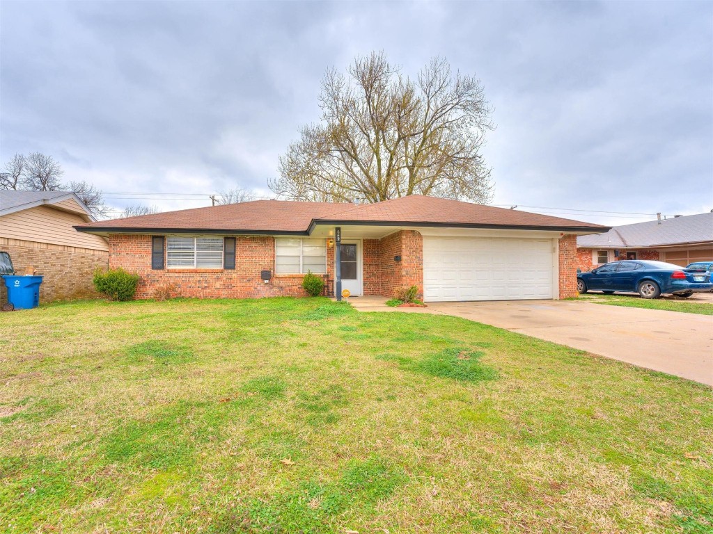 649 Juniper Avenue, Midwest City, OK 73130 single story home featuring a garage and a front yard