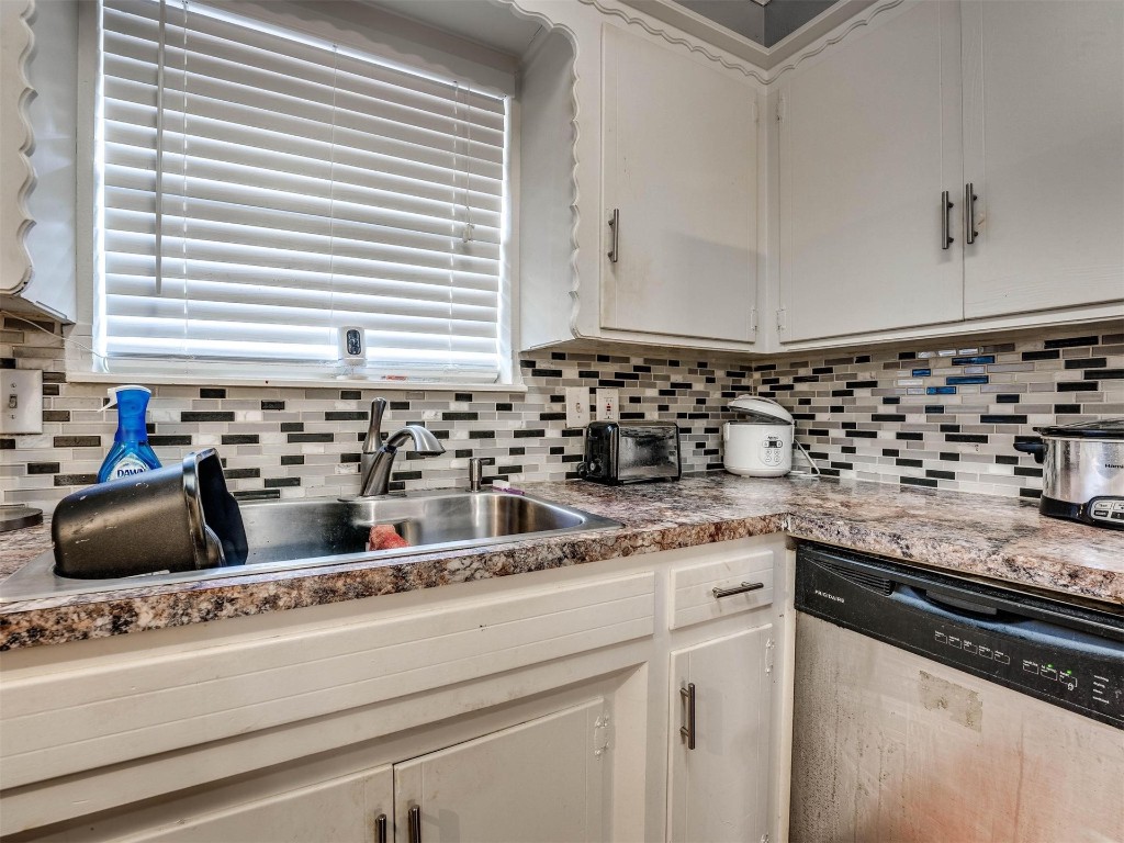 649 Juniper Avenue, Midwest City, OK 73130 kitchen with white cabinets, sink, dishwasher, and backsplash