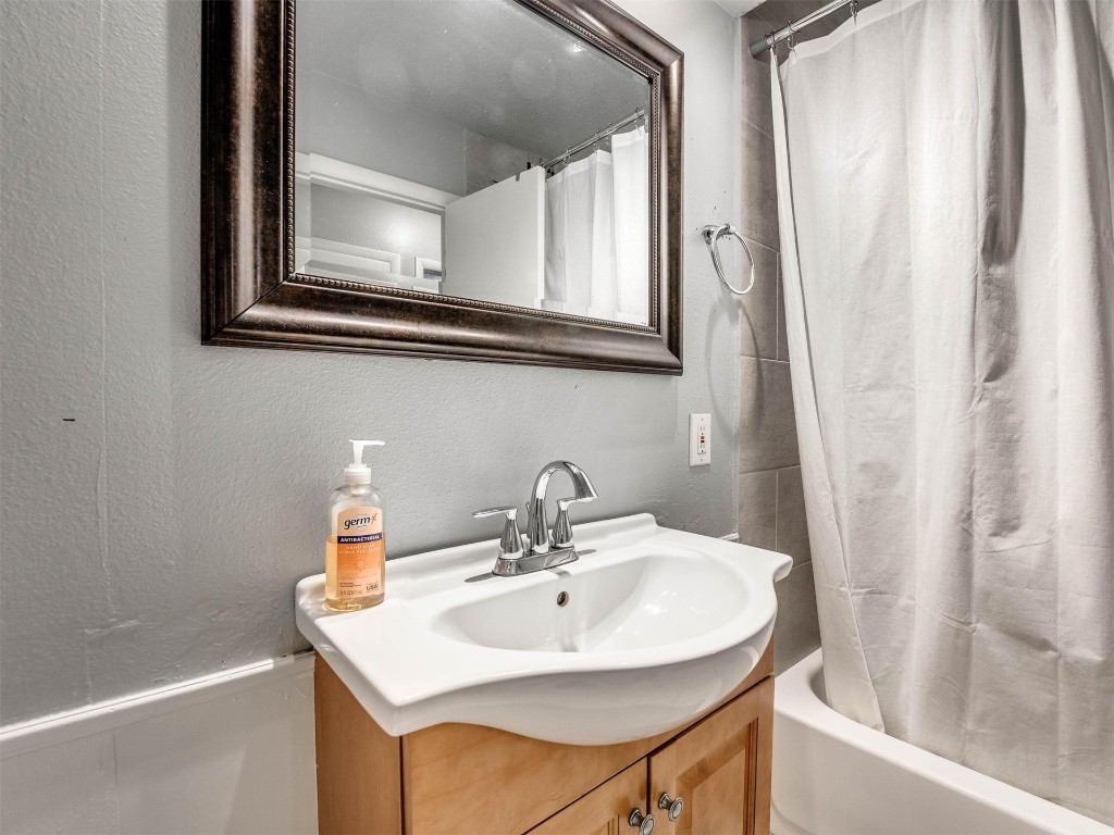 649 Juniper Avenue, Midwest City, OK 73130 bathroom with vanity with extensive cabinet space and shower / bathtub combination with curtain