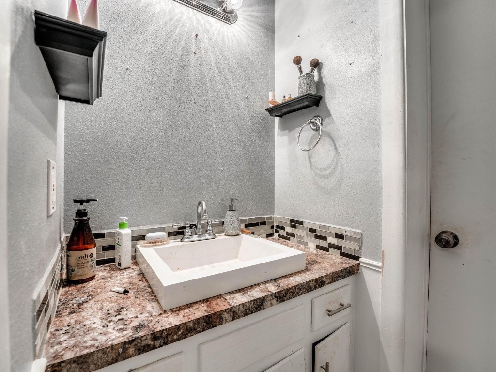 649 Juniper Avenue, Midwest City, OK 73130 bathroom featuring backsplash and vanity