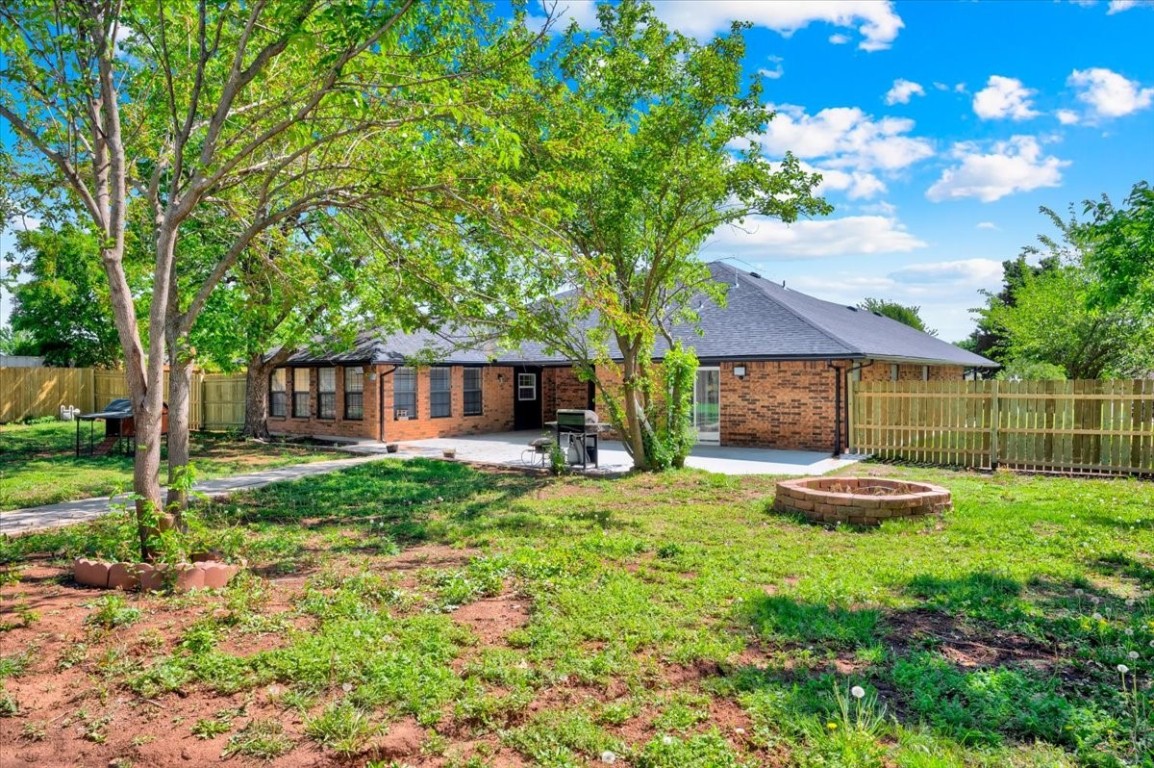 729 N Falcon Way, Mustang, OK 73064 view of yard with a patio and an outdoor fire pit