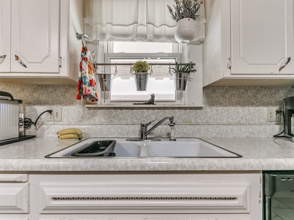 1800 NW 31st Street, Oklahoma City, OK 73118 kitchen with sink, tasteful backsplash, and white cabinetry