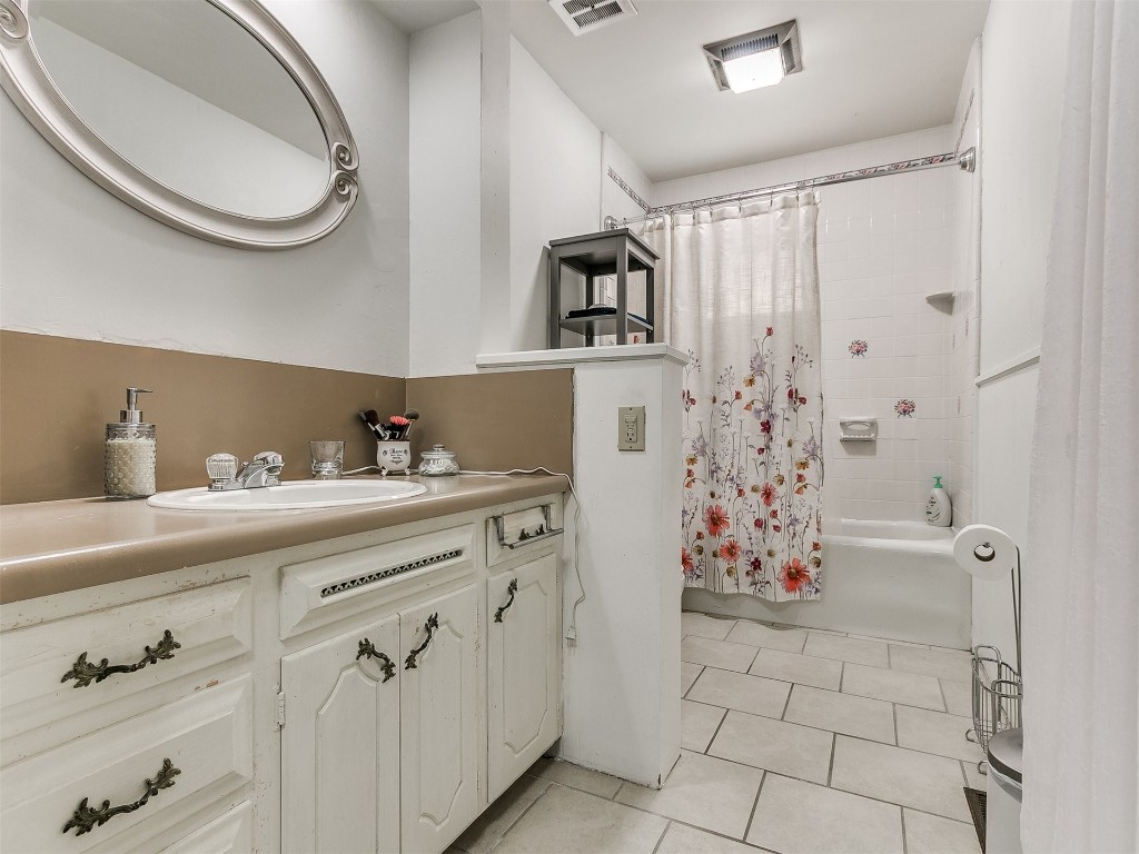 1800 NW 31st Street, Oklahoma City, OK 73118 bathroom with tile floors, vanity, and shower / bath combo with shower curtain