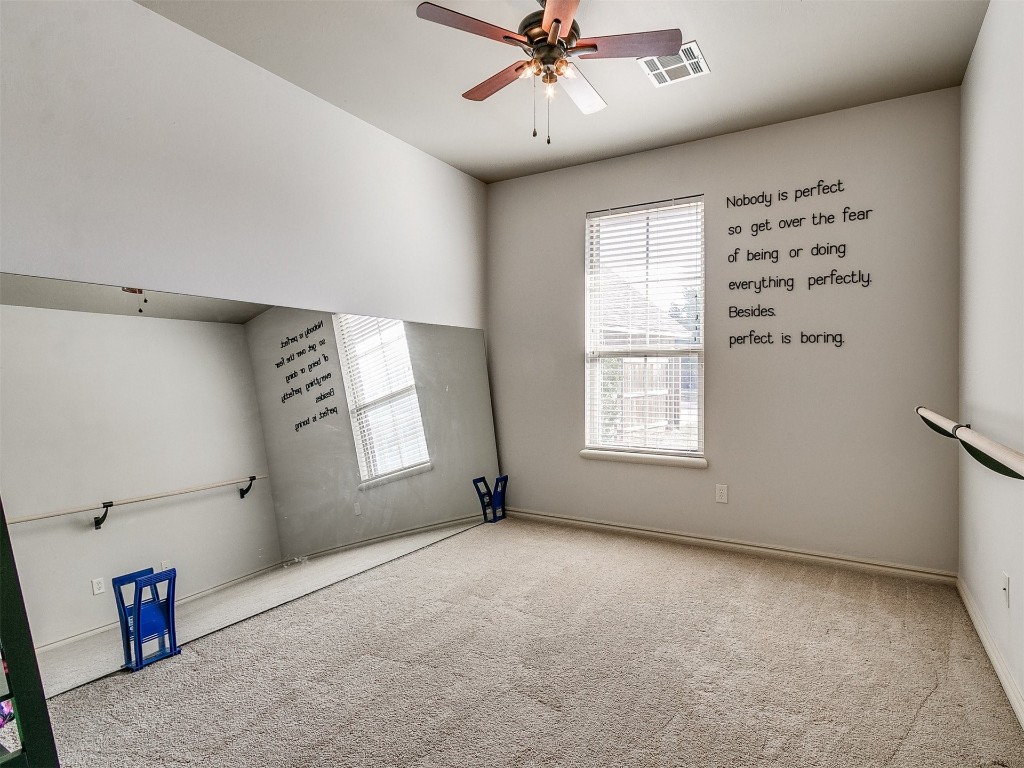 917 NW 195th Place, Edmond, OK 73012 empty room with carpet and ceiling fan