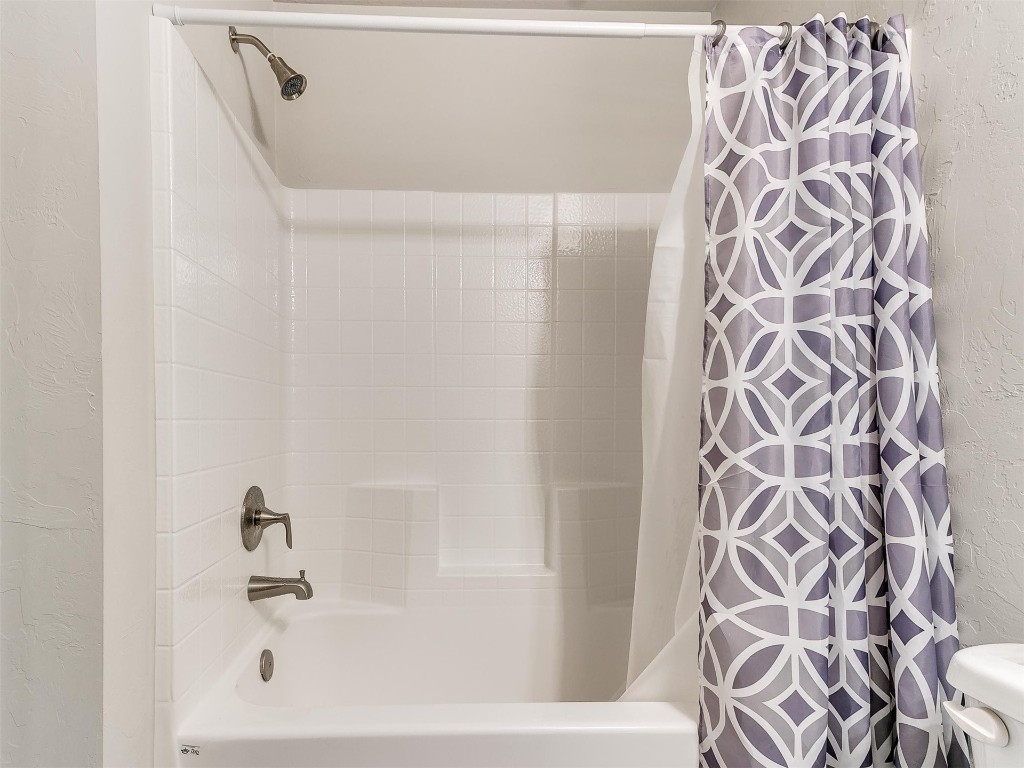 1901 Hannah Lane, Oklahoma City, OK 73127 bathroom featuring shower / bathtub combination with curtain and toilet