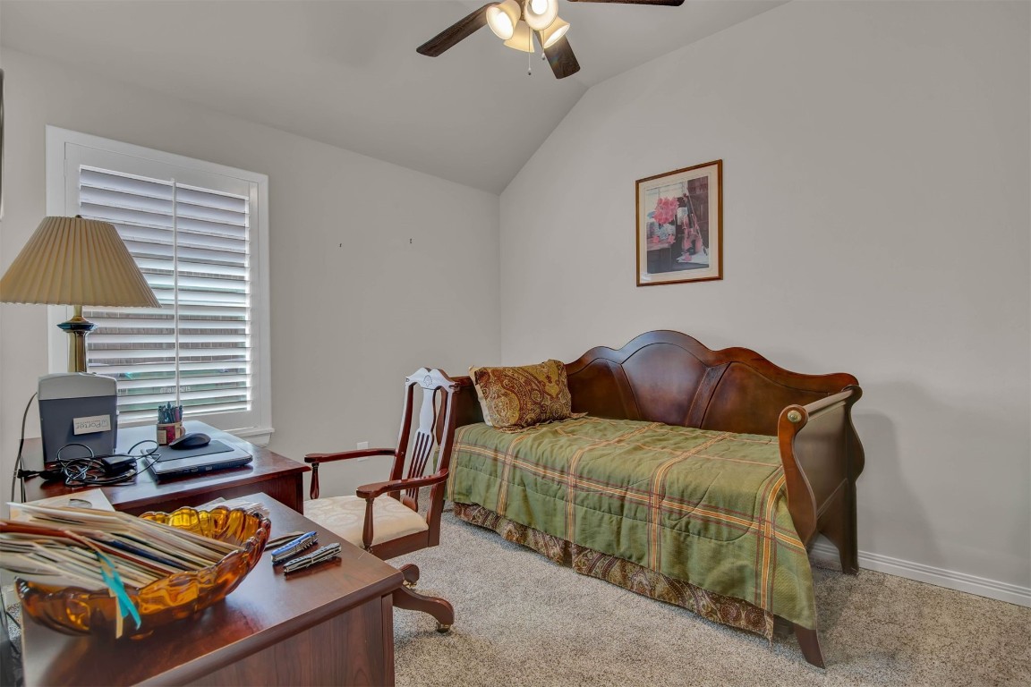 2404 NW 179th Terrace, Edmond, OK 73012 bedroom featuring lofted ceiling, carpet floors, and ceiling fan