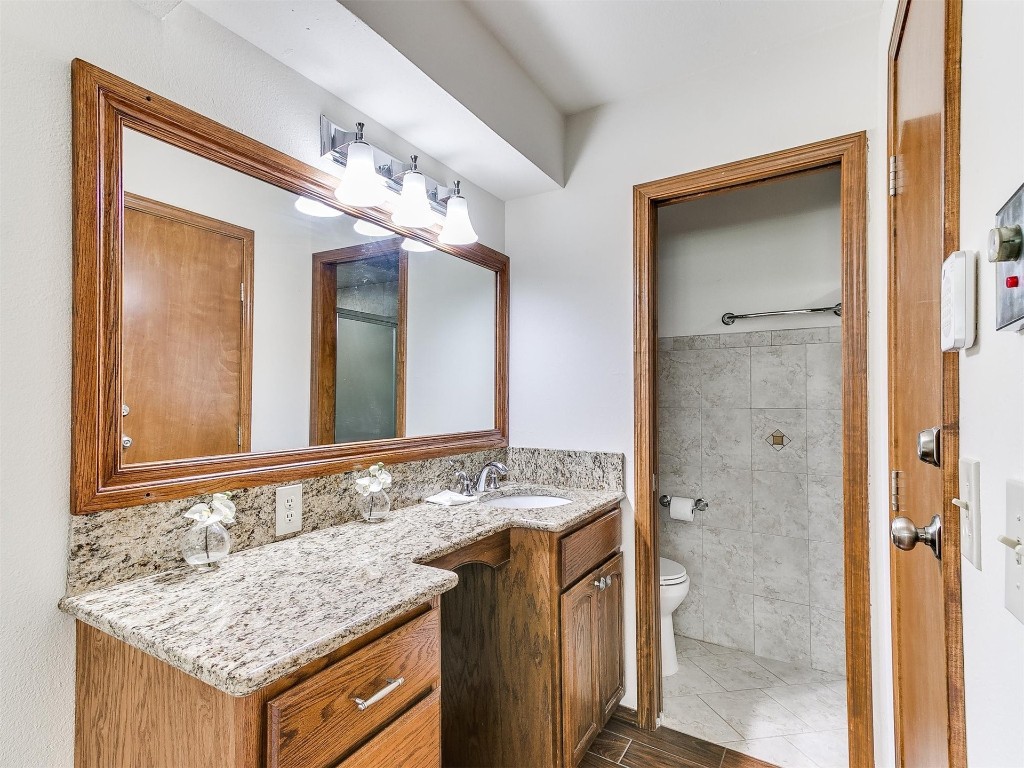 3908 Corbett Drive, Del City, OK 73115 bathroom featuring oversized vanity, tile floors, and toilet