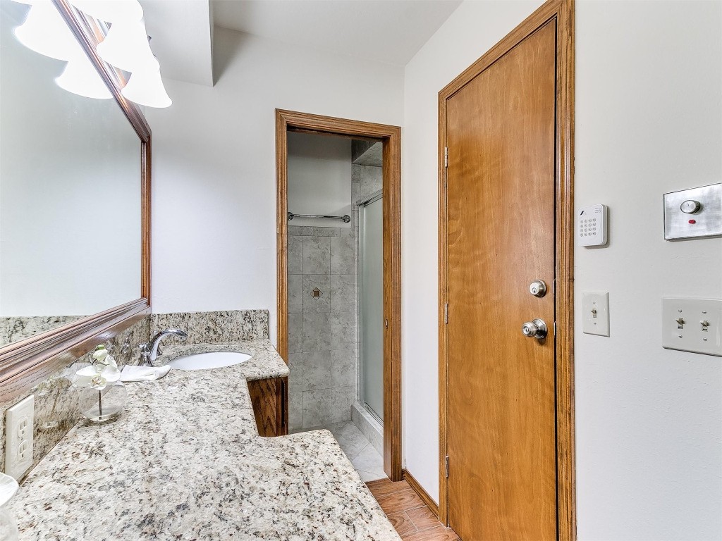 3908 Corbett Drive, Del City, OK 73115 bathroom featuring a shower with door and vanity