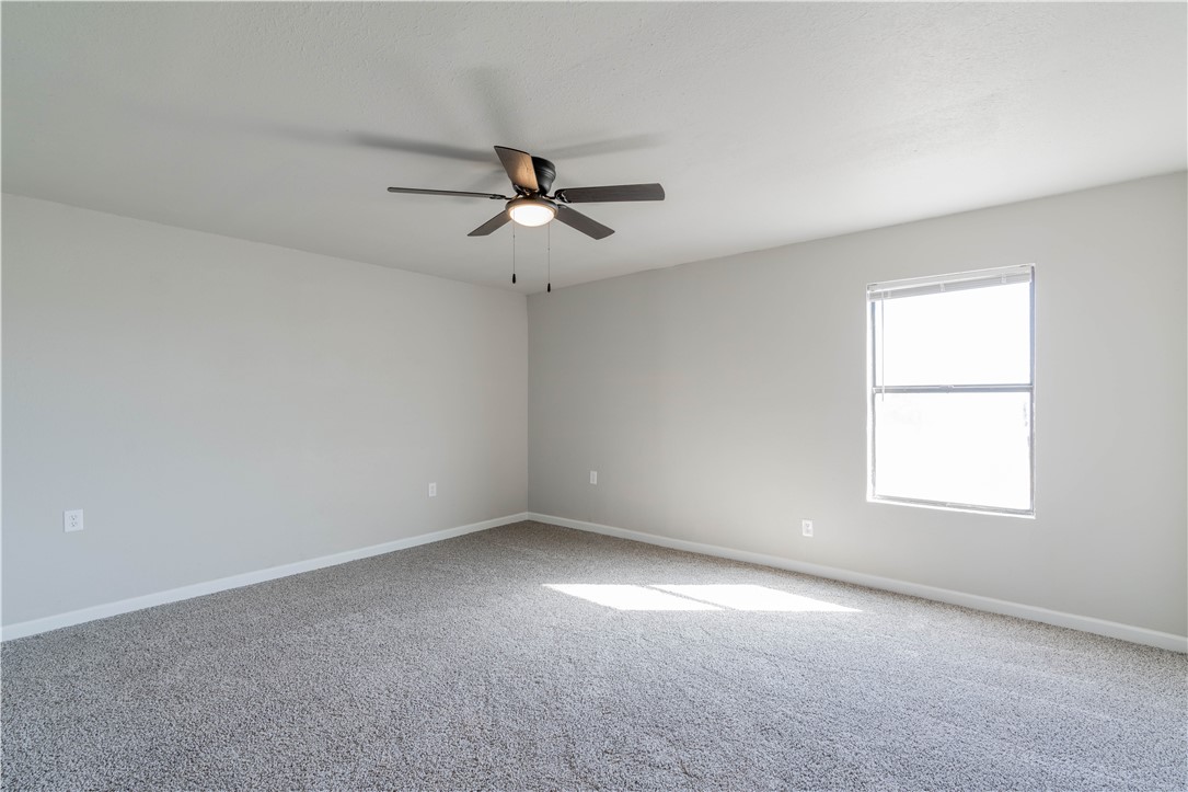 3820 Tranquill Terrace, Guthrie, OK 73044 carpeted spare room featuring ceiling fan