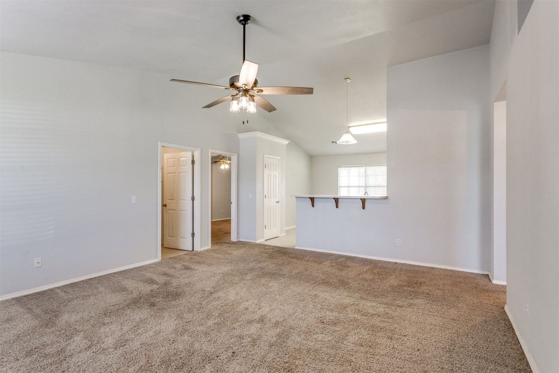 949 NW 15th Street, Moore, OK 73160 unfurnished room with ceiling fan, carpet floors, and lofted ceiling