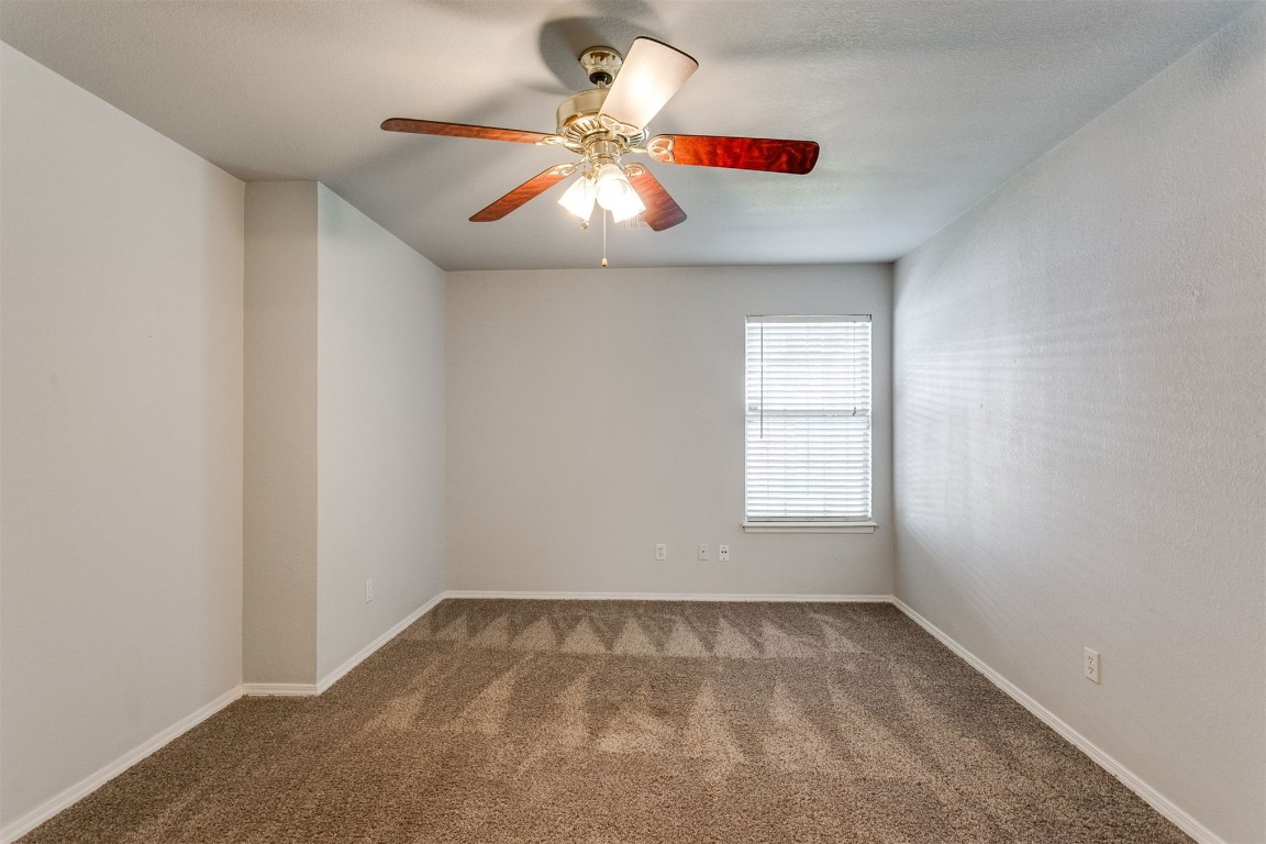 949 NW 15th Street, Moore, OK 73160 unfurnished room featuring ceiling fan and carpet