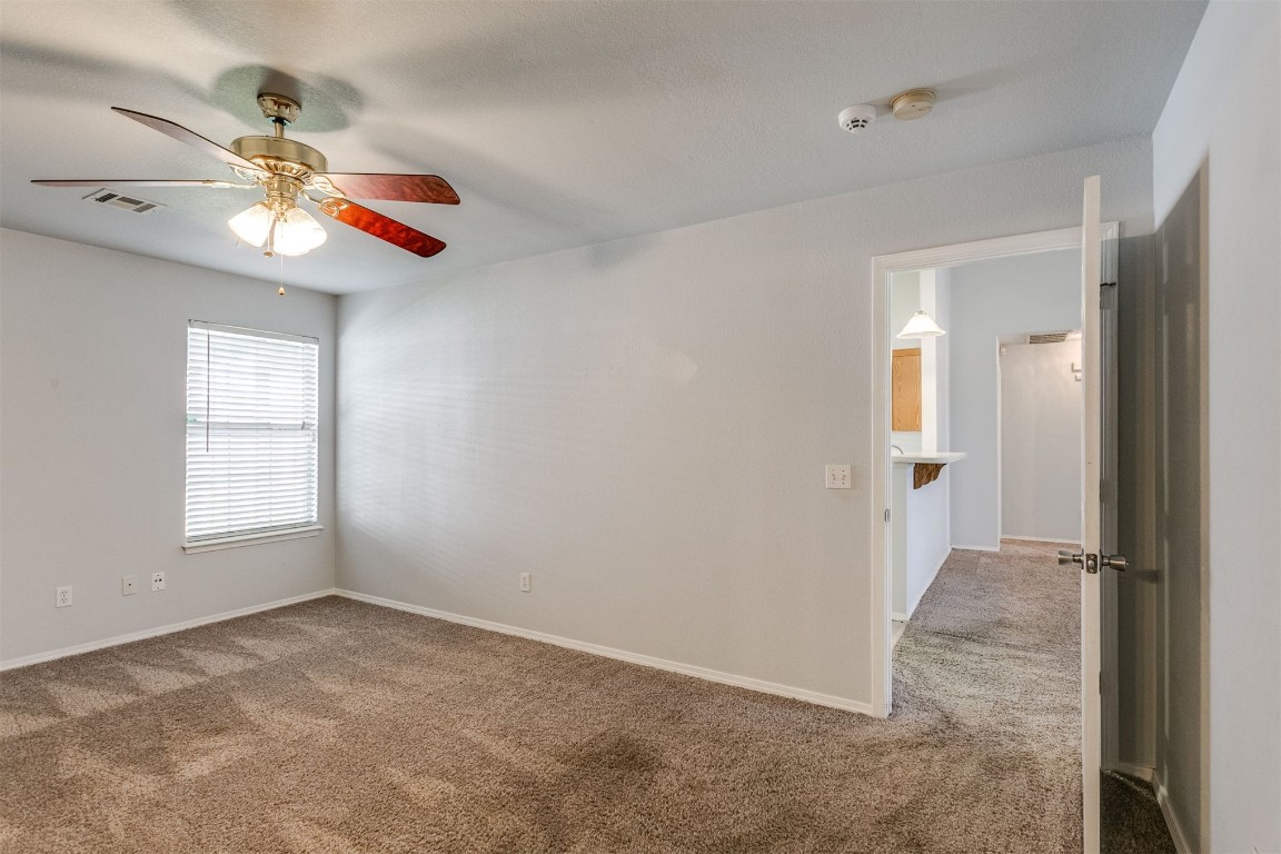 949 NW 15th Street, Moore, OK 73160 empty room featuring ceiling fan and carpet flooring