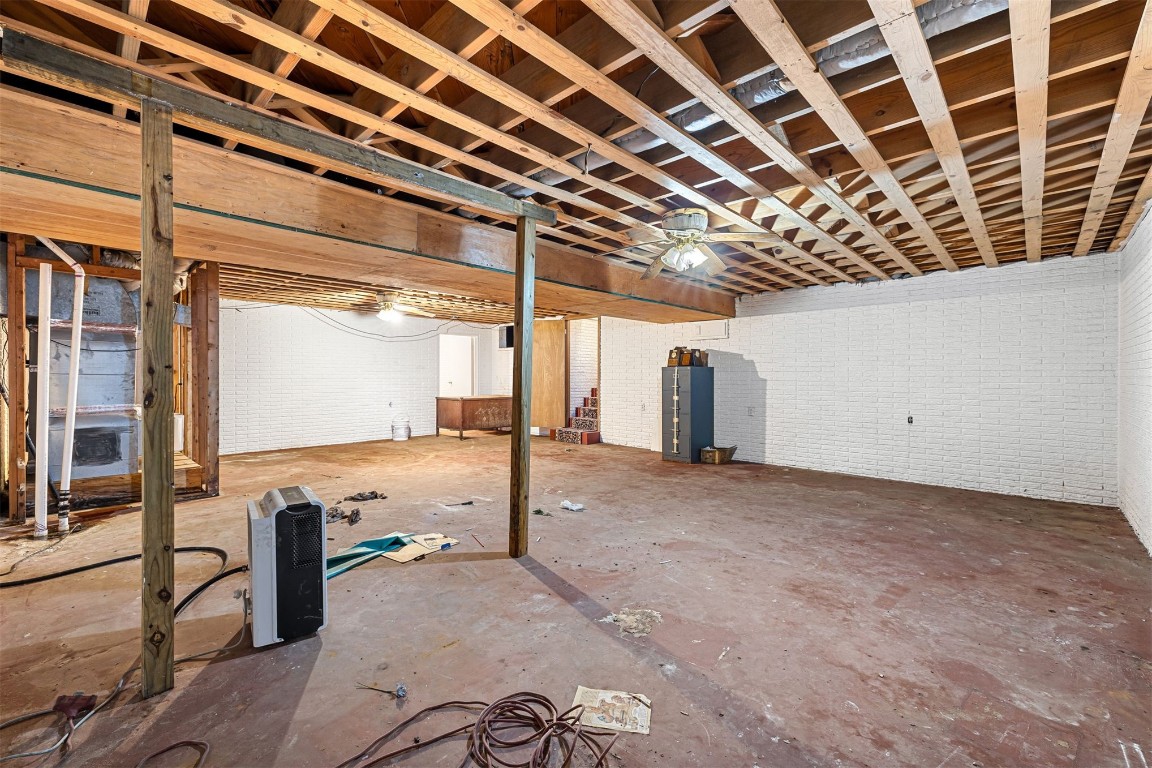2500 S Choctaw Avenue, El Reno, OK 73036 basement featuring ceiling fan and brick wall