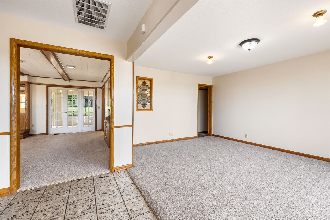 2500 S Choctaw Avenue, El Reno, OK 73036 spare room featuring light colored carpet and french doors