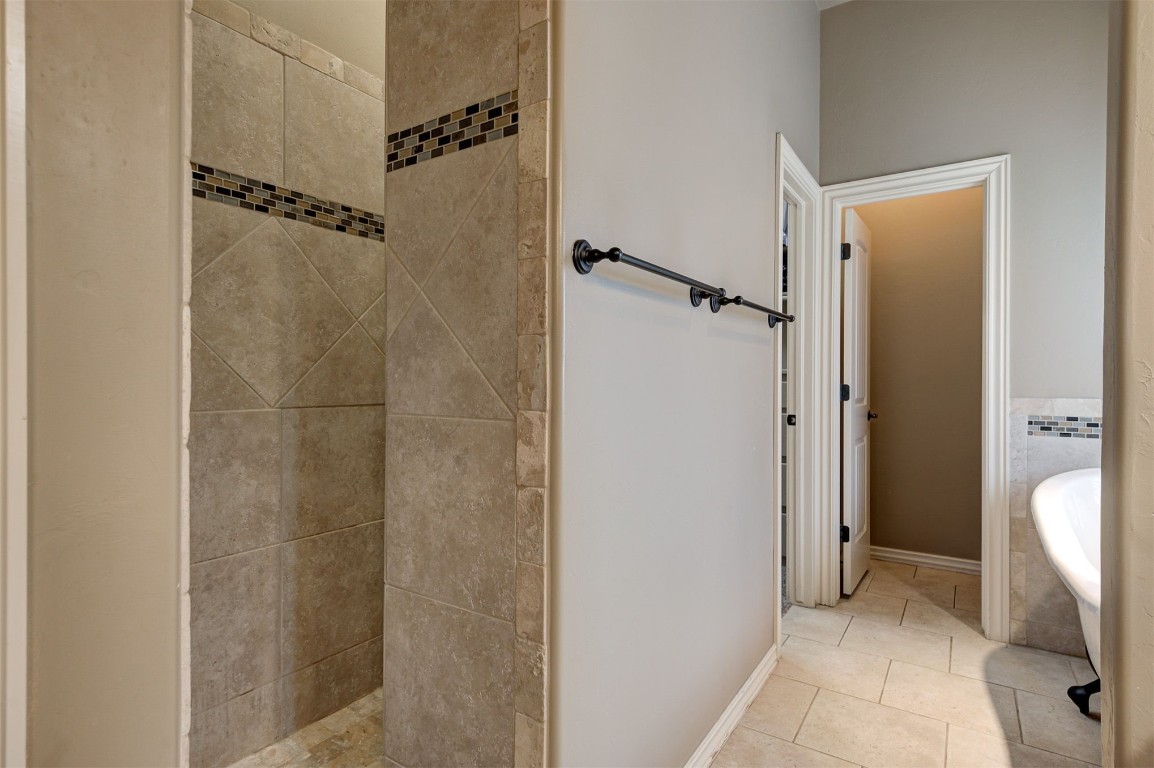 18125 Haslemere Lane, Edmond, OK 73012 bathroom featuring independent shower and bath and tile floors