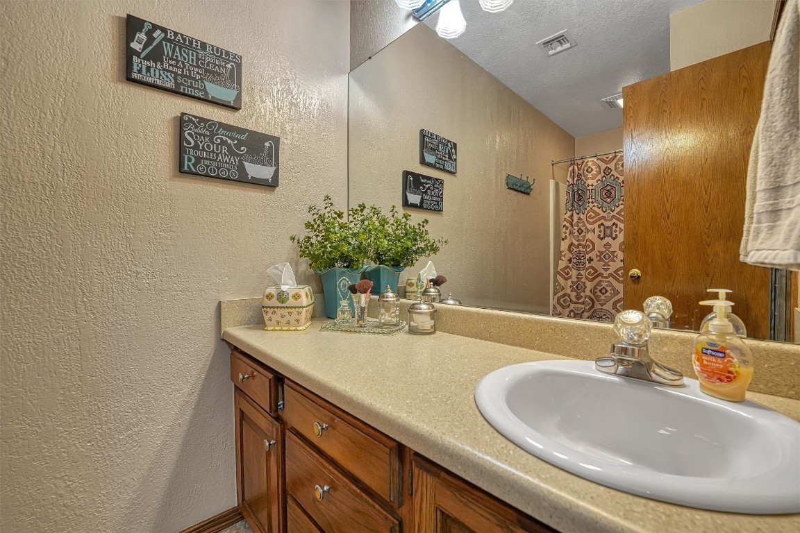 20290 E County Road 175, Elmer, OK 73539 bathroom featuring vanity and a textured ceiling