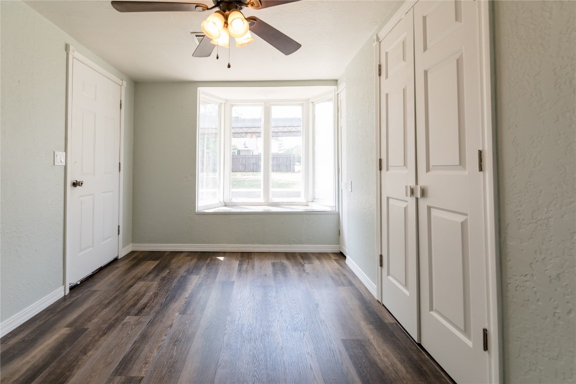 521 N State Avenue, Elk City, OK 73644 empty room with ceiling fan and dark hardwood / wood-style floors