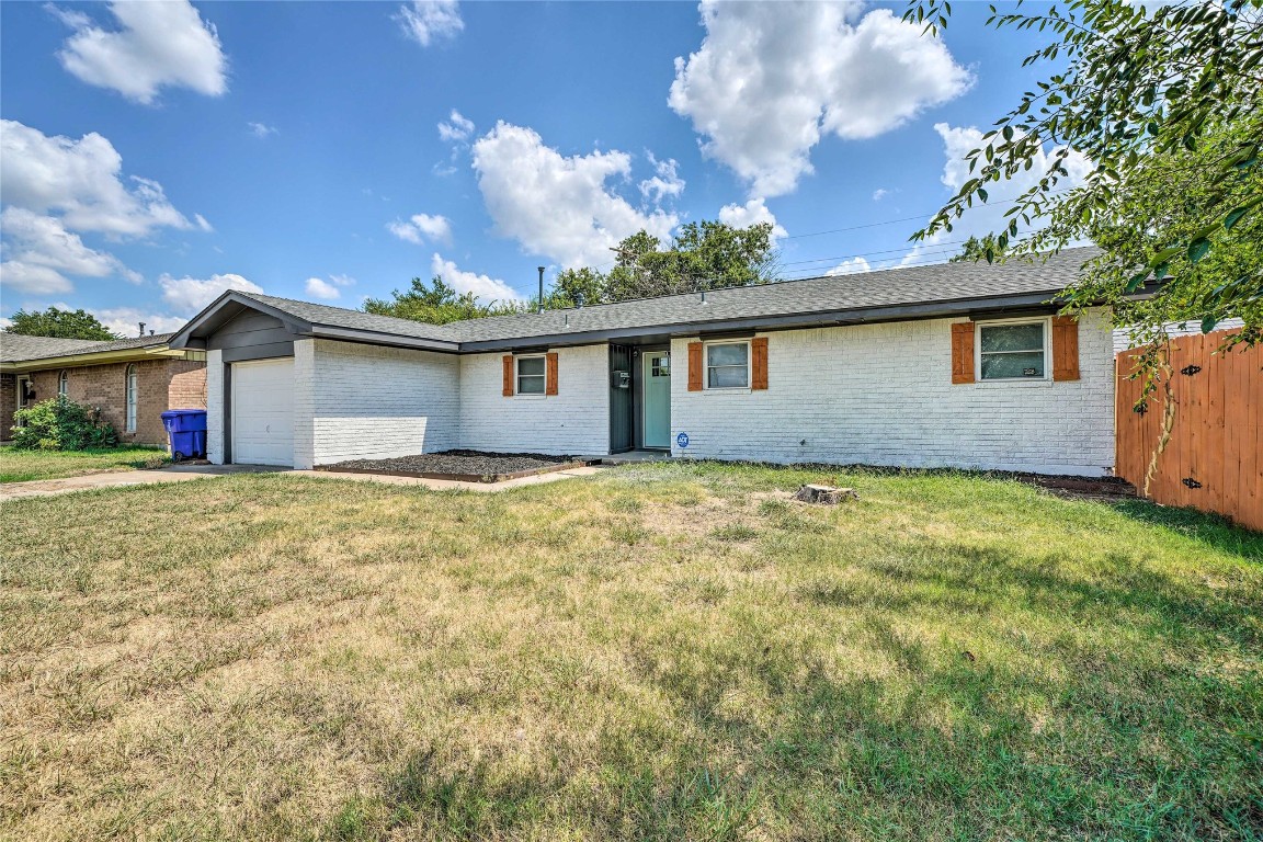 1309 Keystone Lane, Norman, OK 73071 single story home with a front lawn and a garage