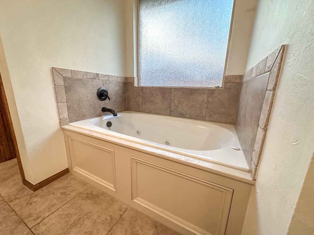 9116 NW 140th Street, Yukon, OK 73099 bathroom featuring tile flooring and a bath