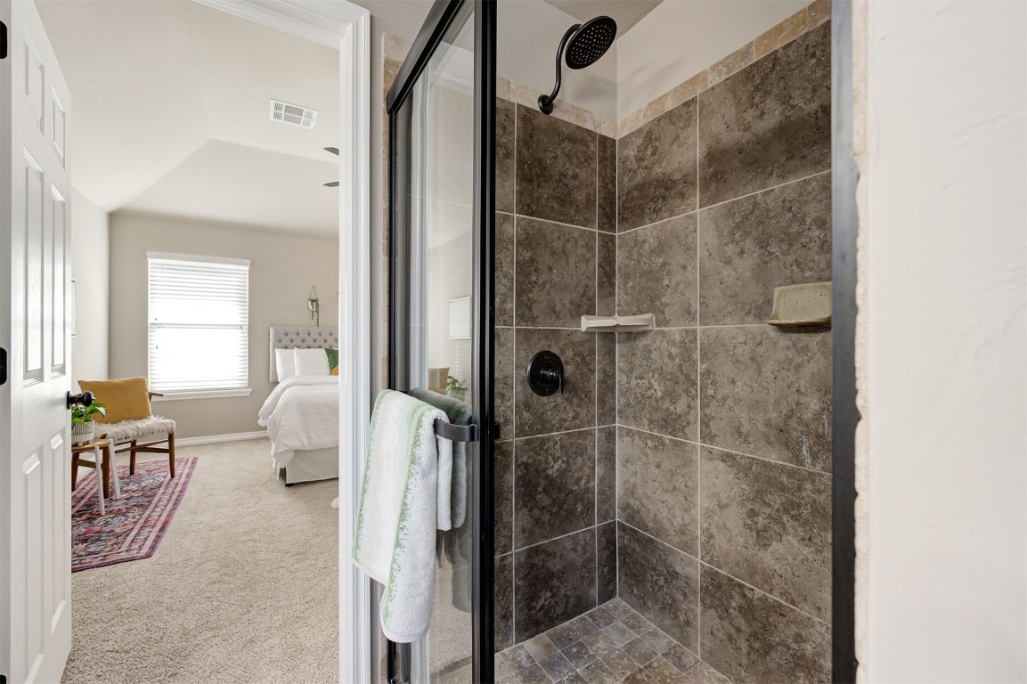 16304 Iron Ridge Road, Edmond, OK 73013 bathroom with a shower with door