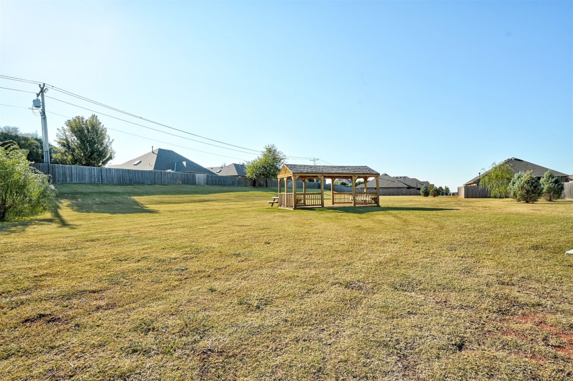 16304 Iron Ridge Road, Edmond, OK 73013 view of yard with a gazebo