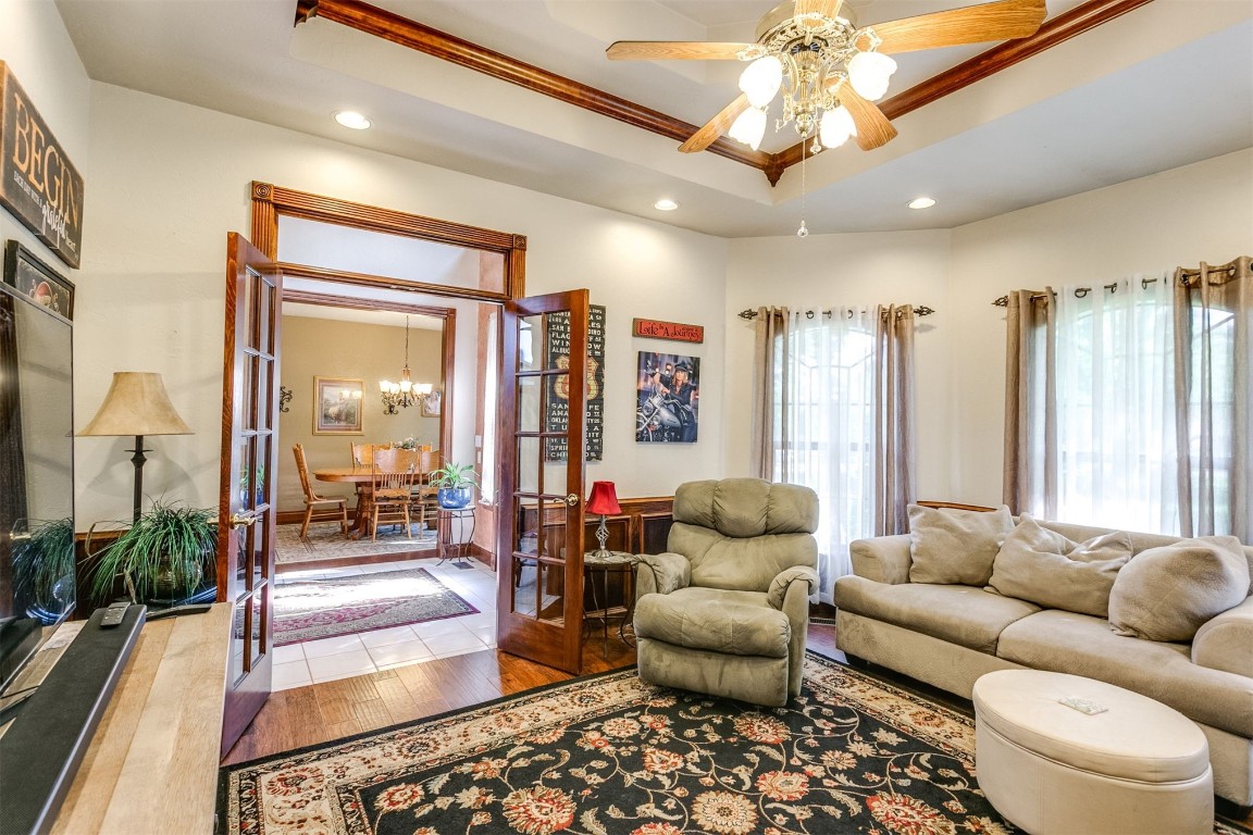 1035 Timberridge Road, Harrah, OK 73045 living room featuring a raised ceiling and ceiling fan