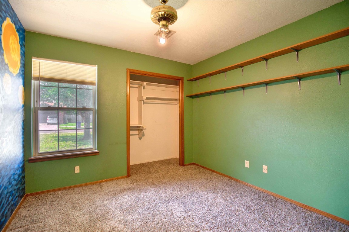 213 Falcon Court, Norman, OK 73069 unfurnished bedroom with a closet and carpet floors