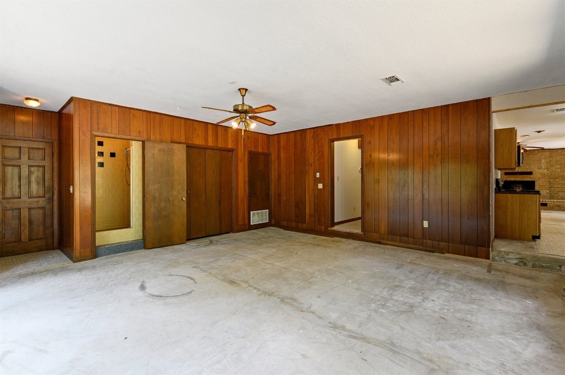 688 Old Hochatown Road, Broken Bow, OK 74728 empty room with ceiling fan and wooden walls