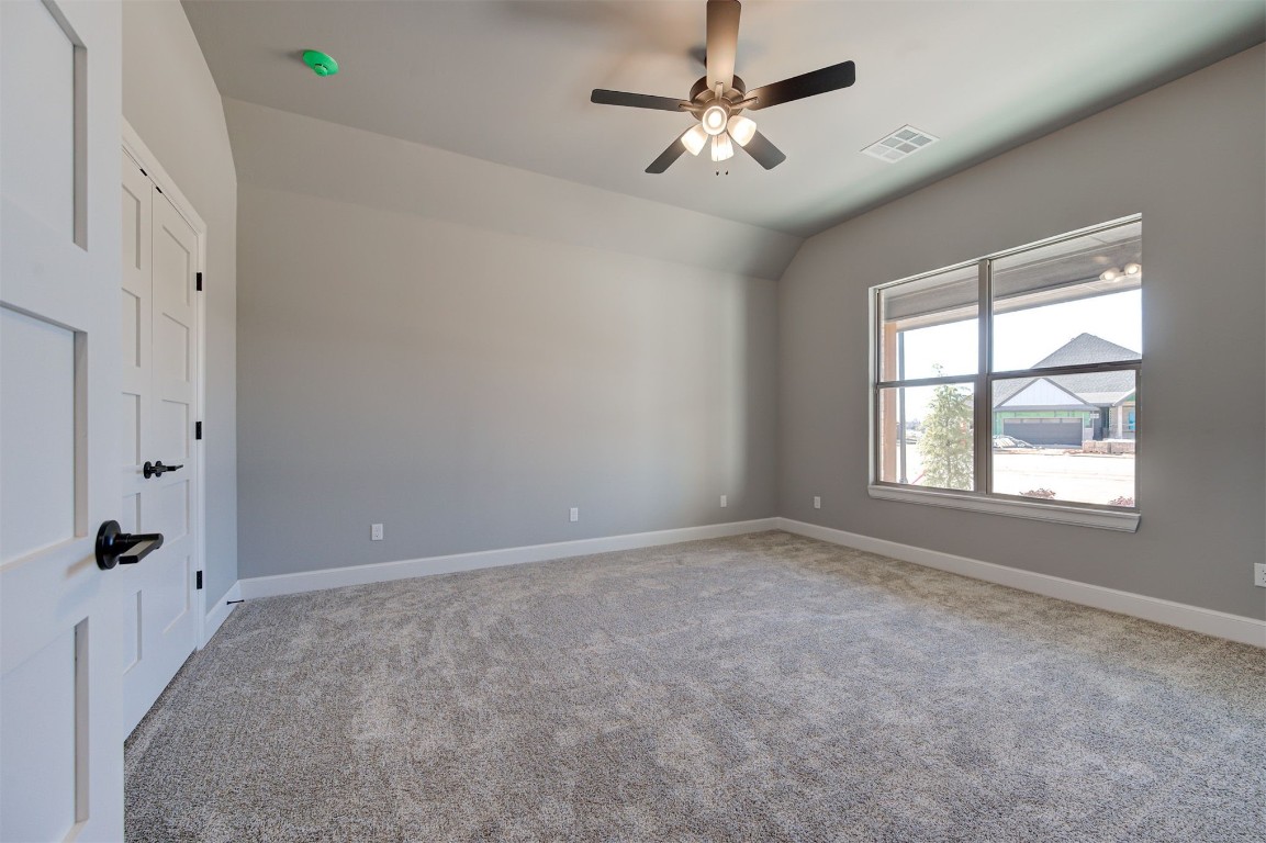 5712 Goldstone Court, Mustang, OK 73064 unfurnished room featuring carpet flooring, ceiling fan, and lofted ceiling