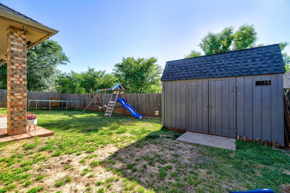 4005 Scissortail Drive, Yukon, OK 73099 view of yard with a playground and a shed