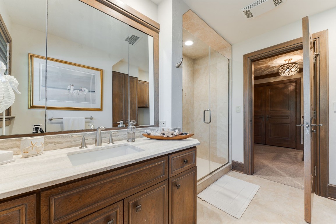 6510 N Hillcrest Avenue, Nichols Hills, OK 73116 bathroom with a shower with shower door, tile floors, and vanity