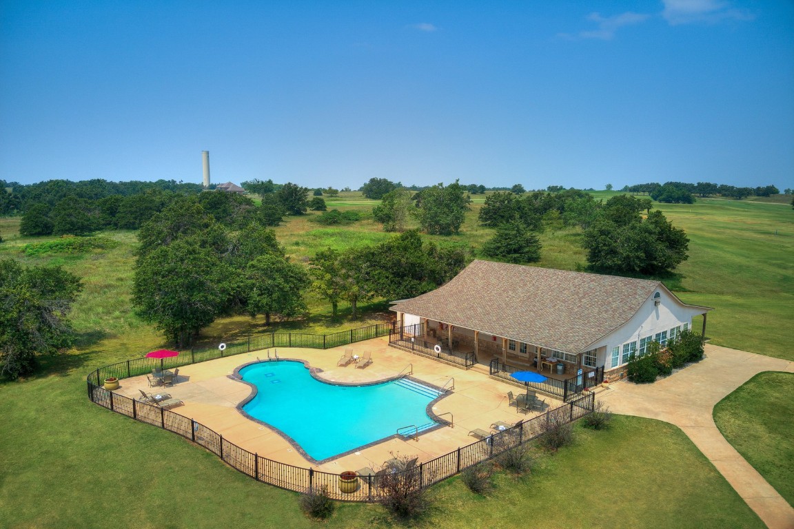 2371 Clubhouse Drive, Blanchard, OK 73010 view of swimming pool featuring a patio area, a yard, and a rural view