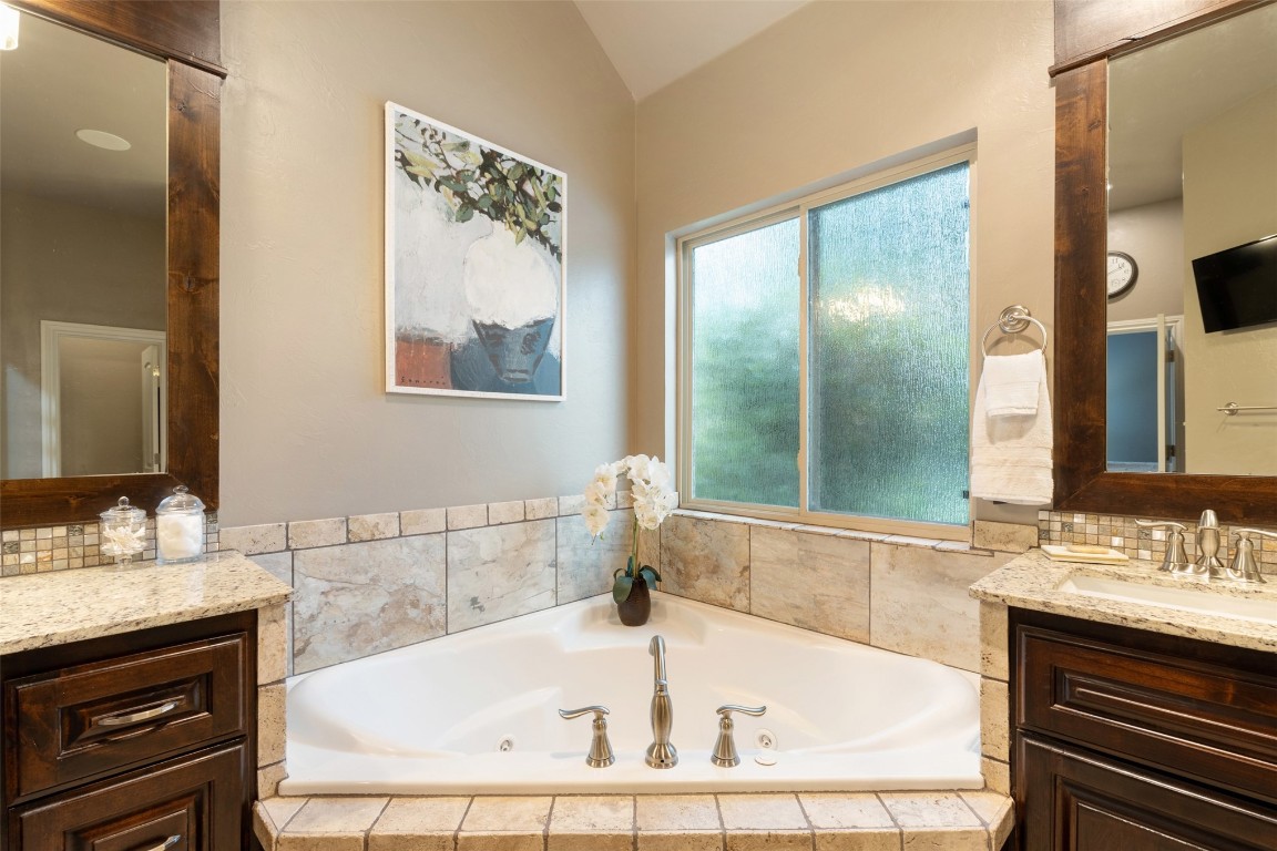 3501 Dornoch Drive, Edmond, OK 73034 bathroom with vaulted ceiling and oversized vanity