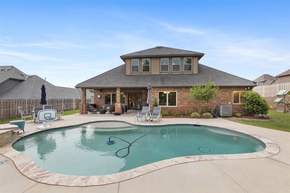 3501 Dornoch Drive, Edmond, OK 73034 view of swimming pool featuring central AC and a patio area