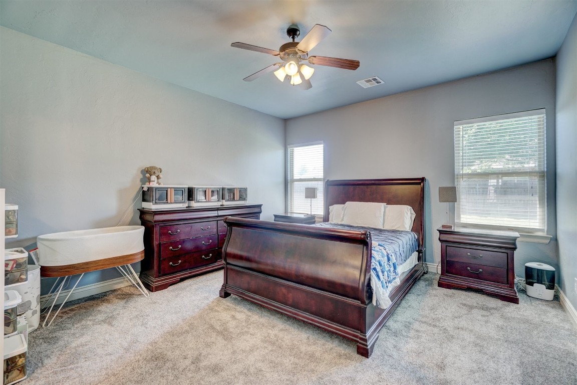 16009 Petaluma Place, Edmond, OK 73013 carpeted bedroom featuring ceiling fan