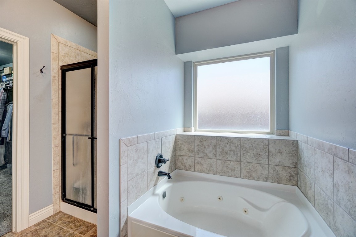 16009 Petaluma Place, Edmond, OK 73013 bathroom with tile floors and plus walk in shower