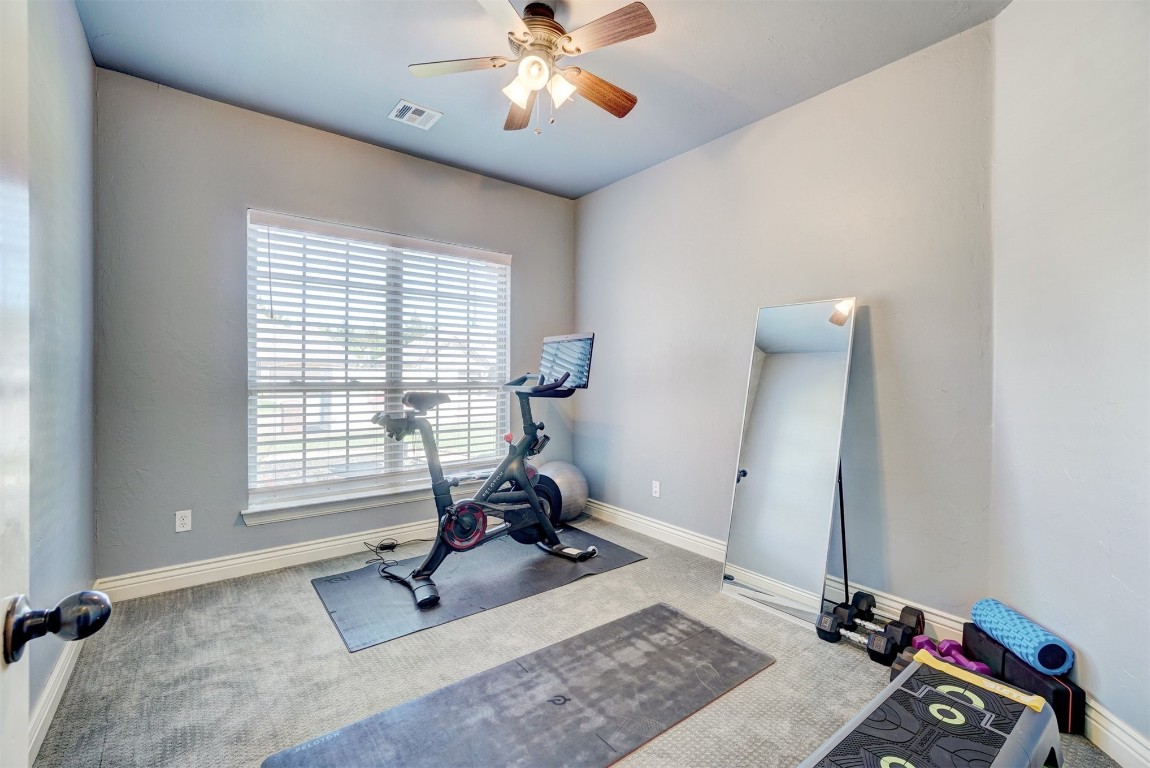 16009 Petaluma Place, Edmond, OK 73013 exercise room featuring carpet floors and ceiling fan