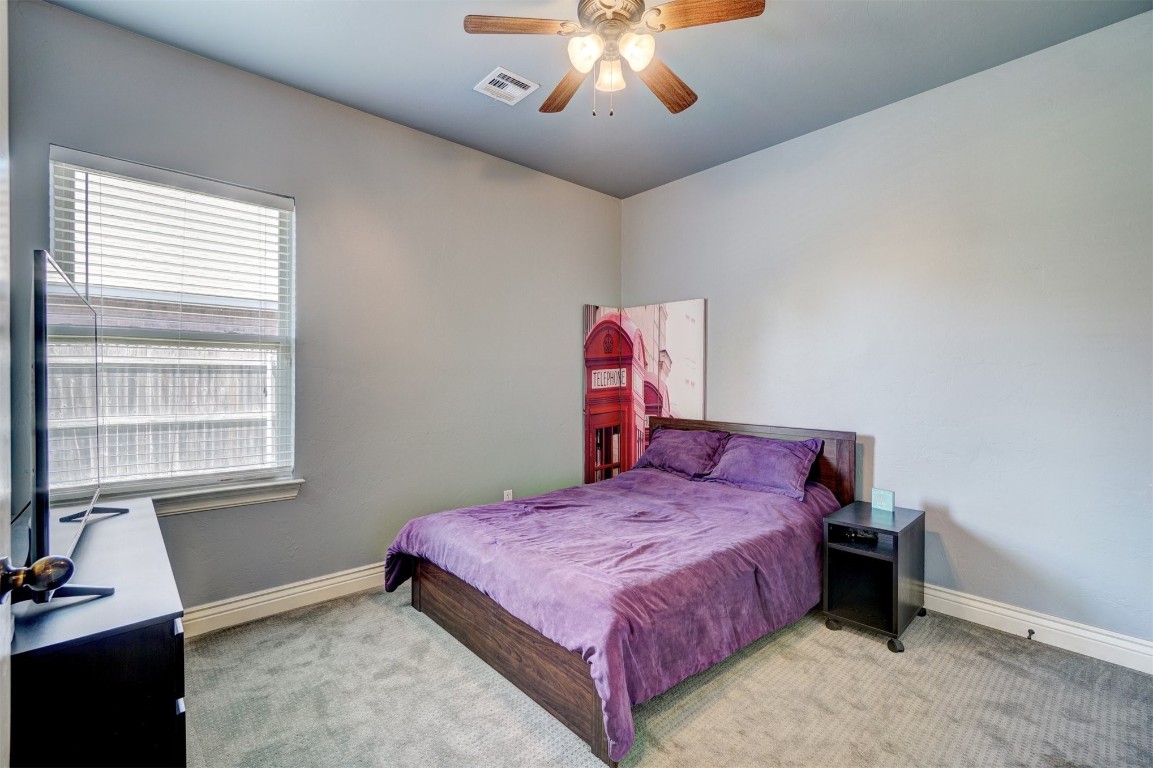 16009 Petaluma Place, Edmond, OK 73013 bedroom featuring ceiling fan and carpet flooring