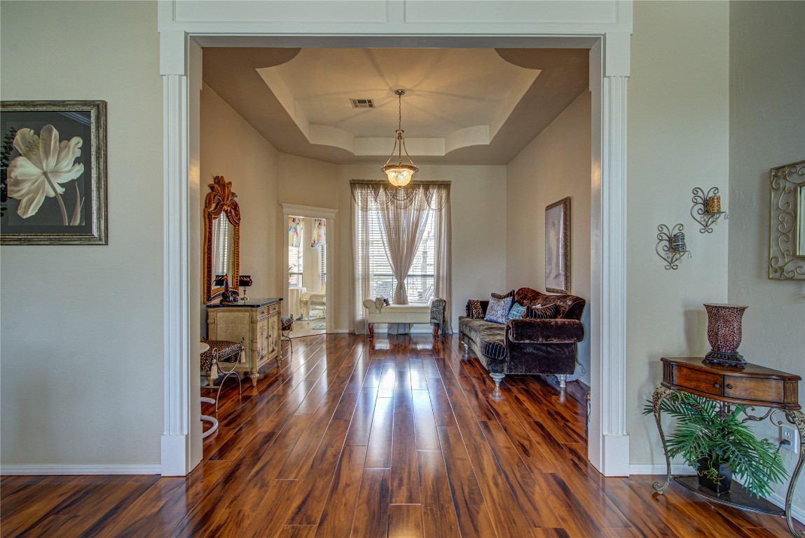 9309 SW 22nd Street, Oklahoma City, OK 73128 foyer entrance featuring dark wood-type flooring and a tray ceiling